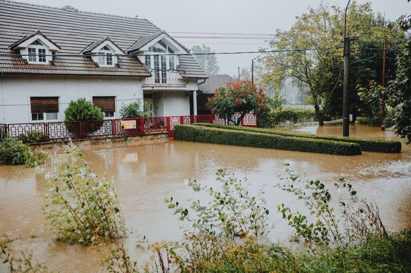 A suburban house surrounded by floodwater after a storm